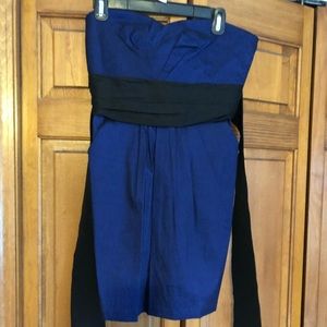 Royal blue cocktail dress with black tie on waist.